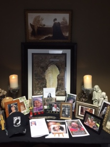 A photo of my brother (left, tall wooden frame behind the POW-MIA cap) and beaded Osiris statue necklace were among my offerings for our group altar for the dead.